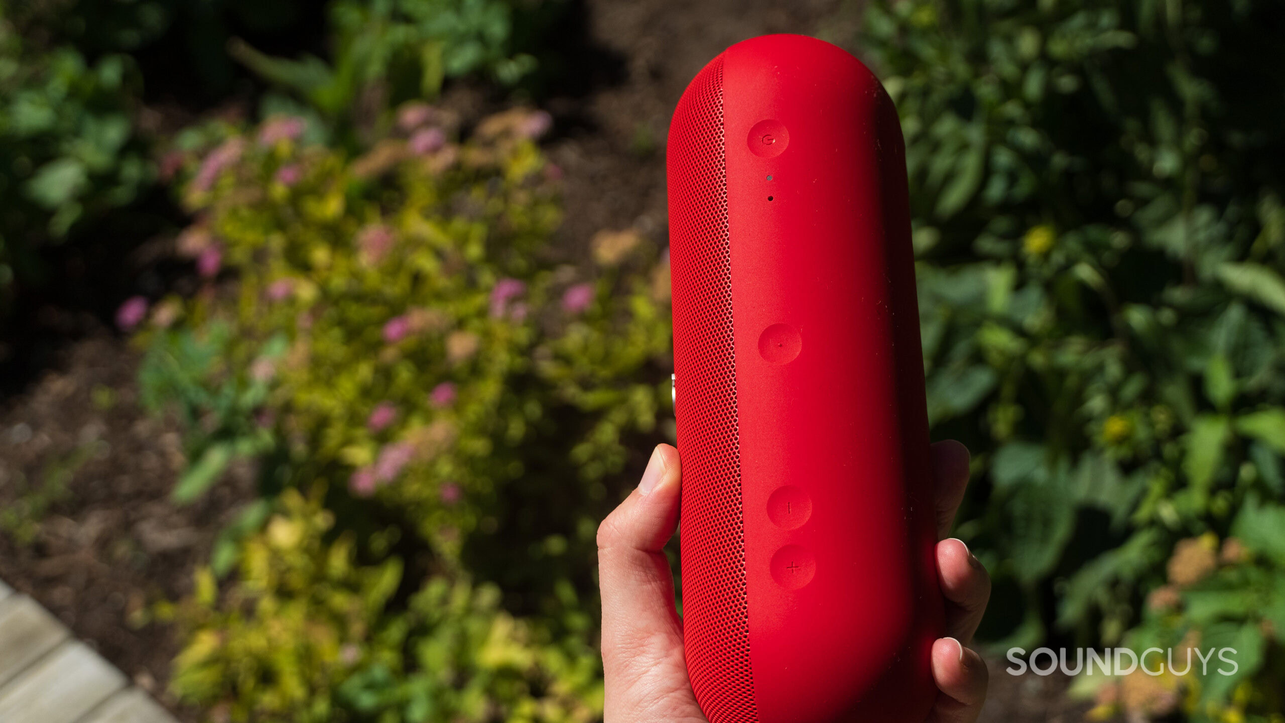 Beats Pill held in hand A hand holds the Beats Pill showing the onboard controls.