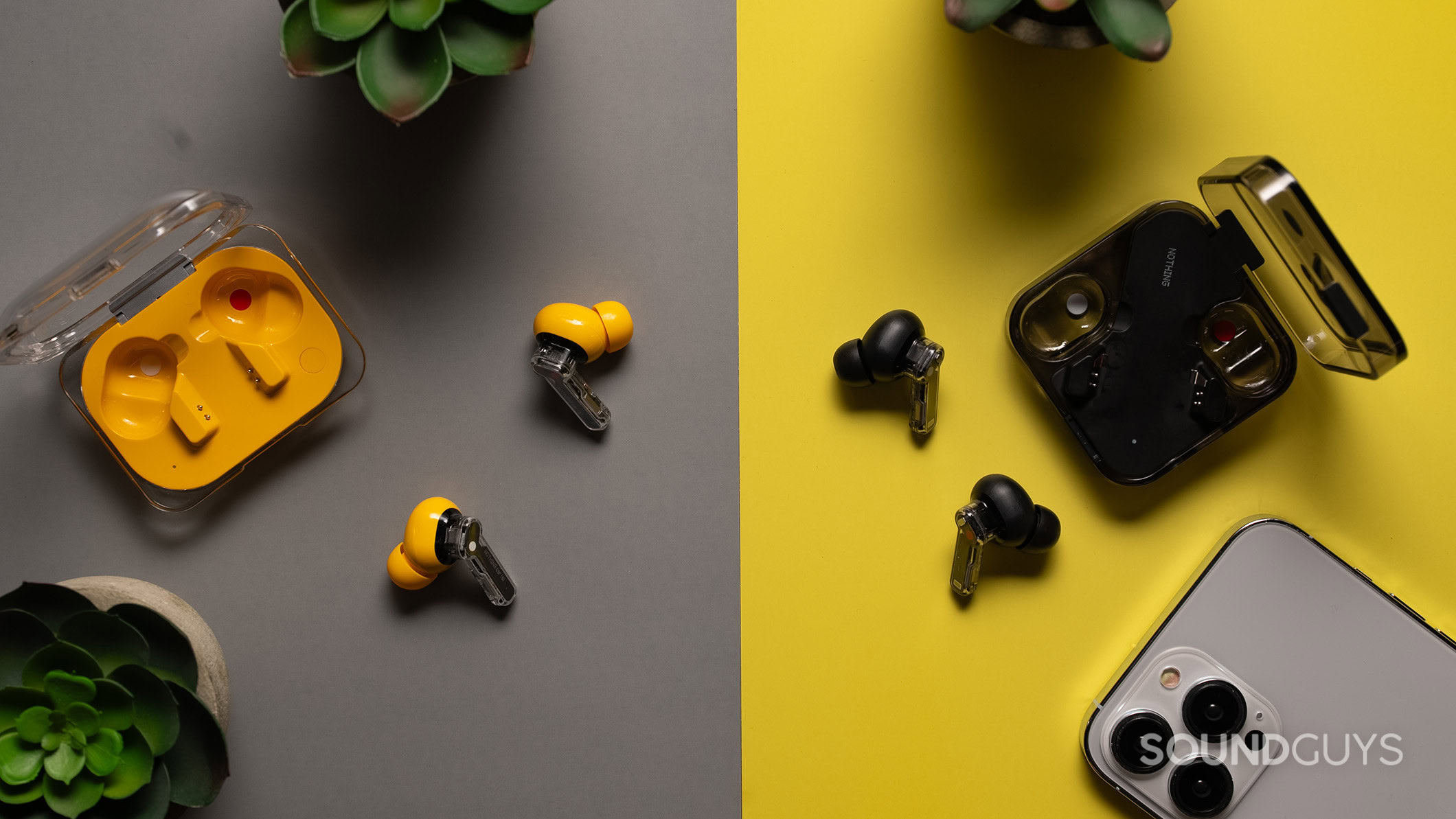 Nothing Ear (a) vs Nothing Ear The Nothing Ear (a) in yellow next to the Nothing Ear in black on a table.